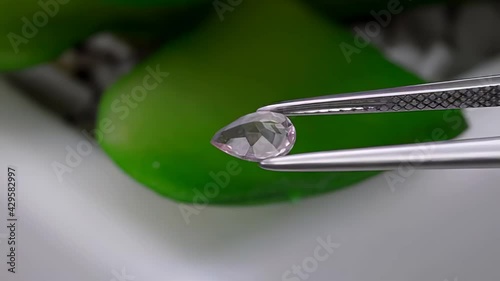 natural morganite gemstone in tweezer on the turn table photo