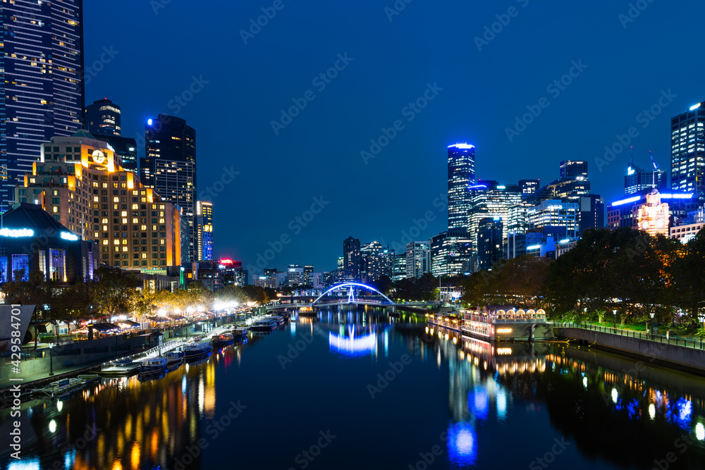 Melbourne, Australia - April 8, 2021: Yarra river and city buildings in evening