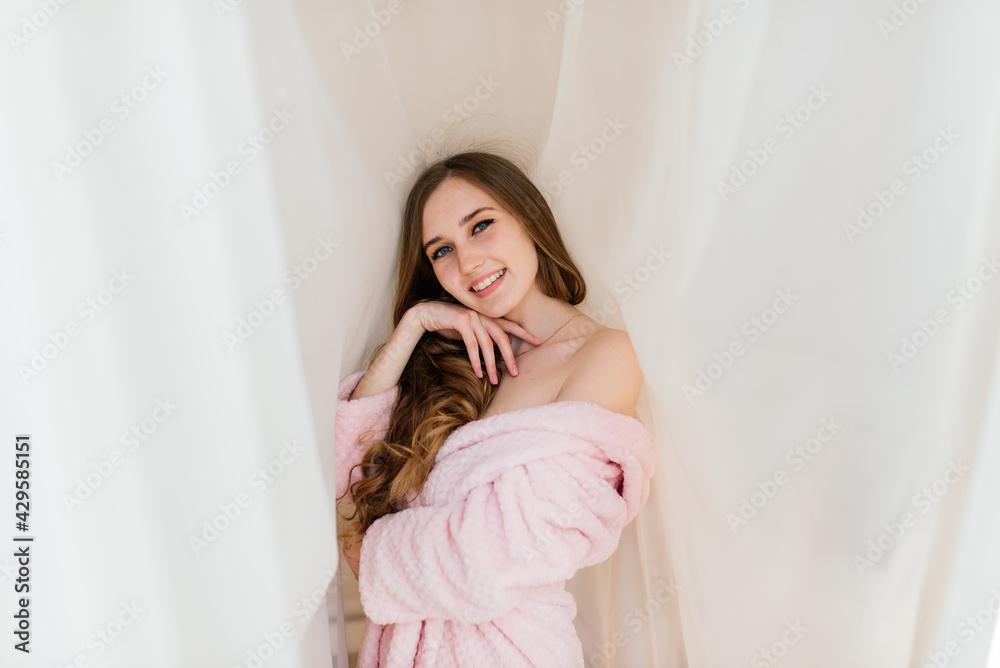 Happy rich young woman wear night robe in modern home hotel, good morning lifestyle concept