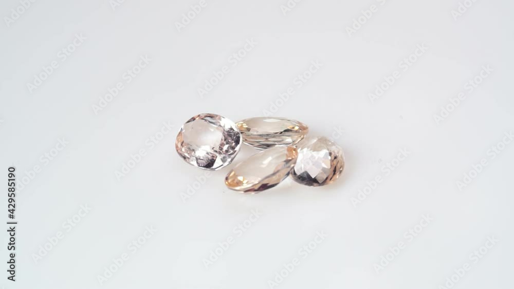 natural morganite gemstone on the white background on the turning table natural morganite gemstone on the white background on the turning table