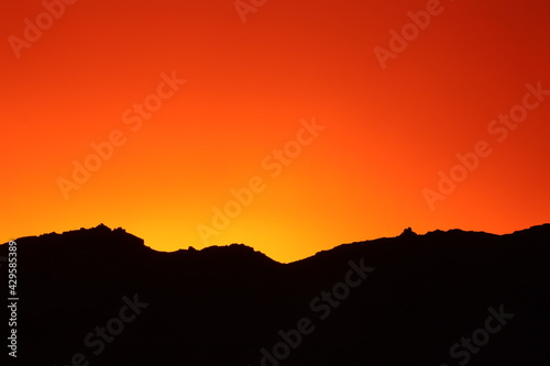 Colorful sunrise over a mountain  under a stormy weather  photographed in the Namib desert in southern Namibia.