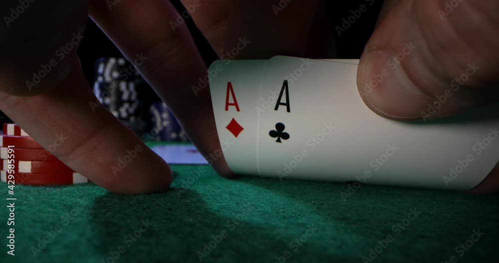 peeking at pocket aces. playing poker in casino with ace cards