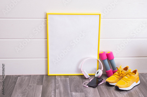 note board, dumbbells, yellow sneakers, headphones and cell phone