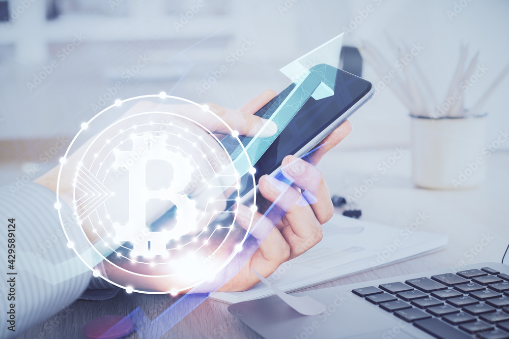 Double exposure of man's hands holding and using a phone and crypto currency blockchain theme drawing. Double exposure of man's hands holding and using a phone and crypto currency blockchain theme drawing.