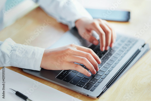 hand woman typing on laptop for search working in office