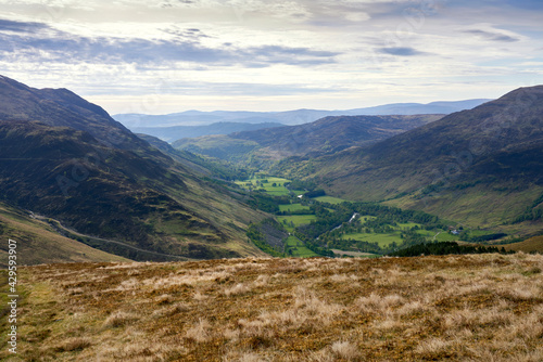 Looking down onto Glen Lyon and River Lyon below the mountain of Carn Gormin with Meall na Aighean to the left in spring. Scottish Highlands, UK Landscapes.