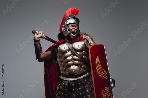 Violent roman warrior in fight pose with sword