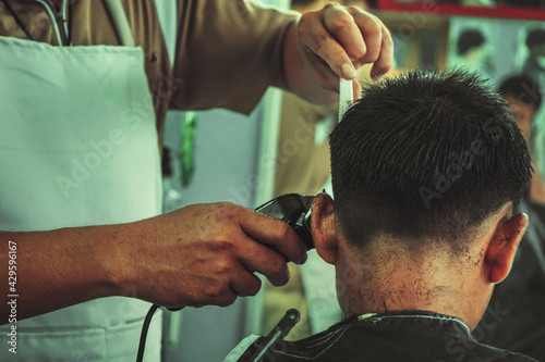 hairstylist in barber shop.Hairdresser makes hairstyle a man