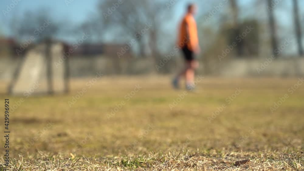Blurred video. Slow motion. Legs of young soccer players during the game in training Blurred video. Slow motion. Legs of young soccer players during the game in training