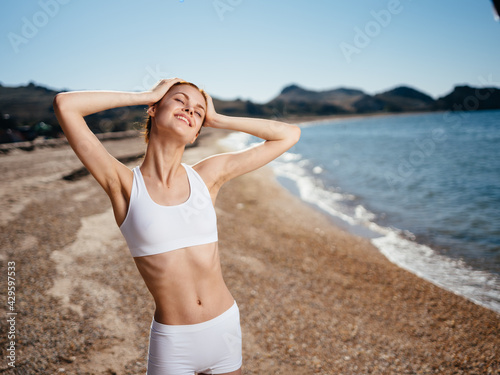 Cheerful woman in swimsuit in the morning on the island Exotic travel fresh air