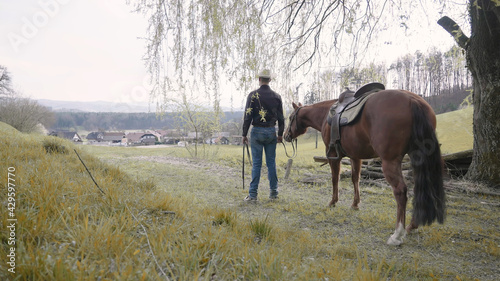 Cowboy and horse enjoy the top hill landscape view © Video_StockOrg