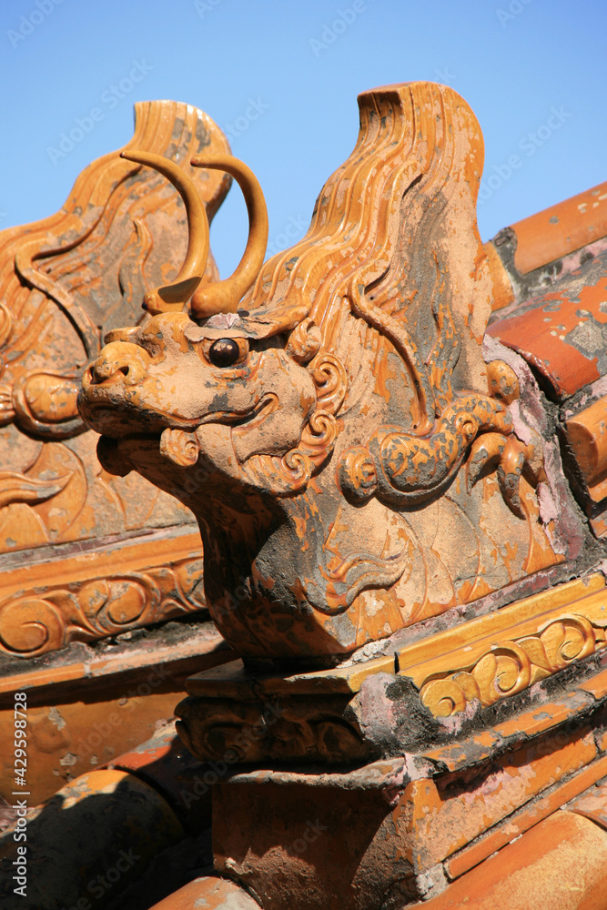 statue of a dragon on the roof of a pavilion at summer palace in beijing (china)