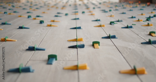 Konstfotografi Ceramic tiles, just laid on the floor, in the form of boards, fixed with a level