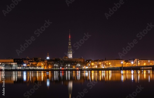 Beautiful view of the city at night by the river. View in Riga, Latvia