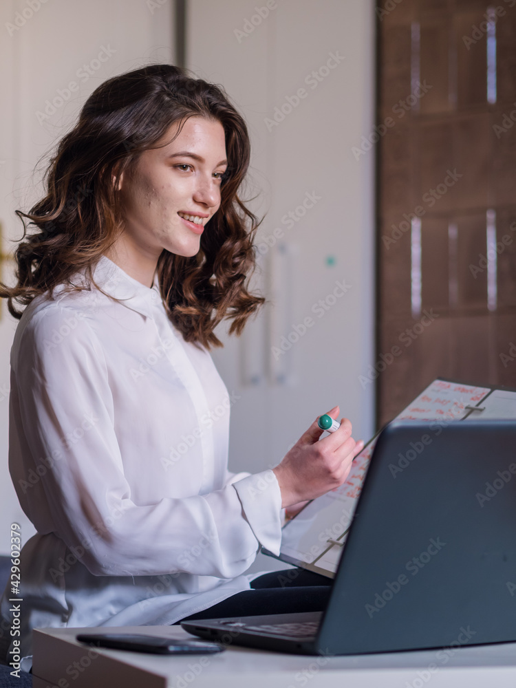 one young happy and smiling young woman, writing on whiteboard at her home. one young happy and smiling young woman, writing on whiteboard at her home.
