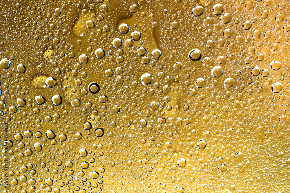 Water droplets and cold vapor on the orange clear glass Water droplets and cold vapor on the orange clear glass