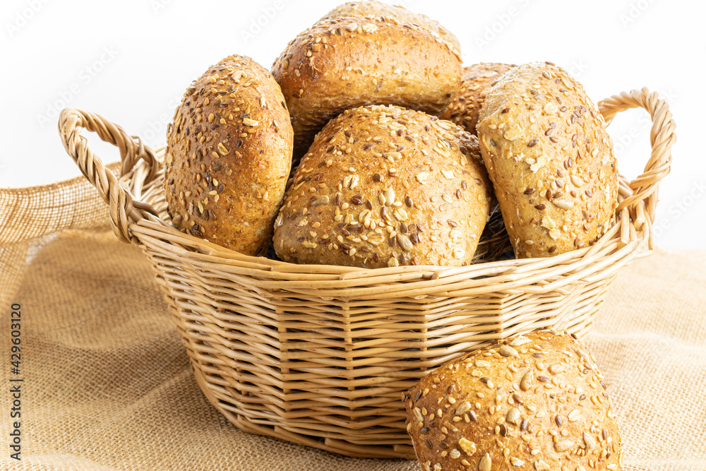 Freshly baked bread. Fresh loaf of rustic traditional bread with wheat grain ear or spike plant on linen texture background. Rye bakery with crusty loaves and crumbs. Healthy Food concept.