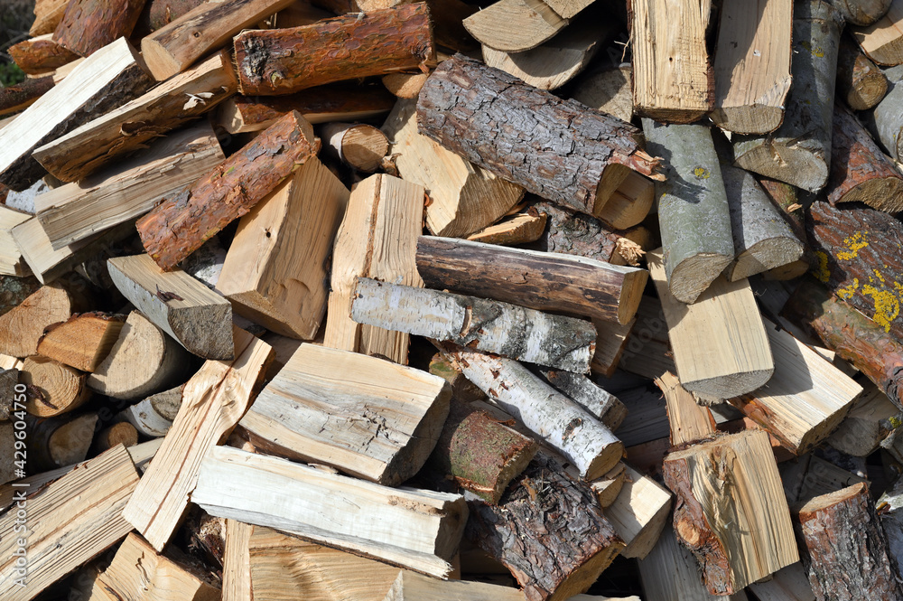 Firewood background - chopped firewood on a stack Firewood background - chopped firewood on a stack