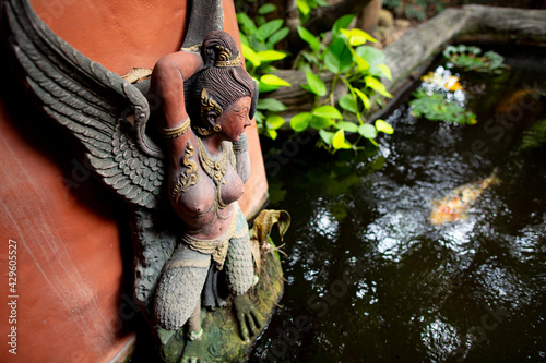 thai stone statue placed in a garden