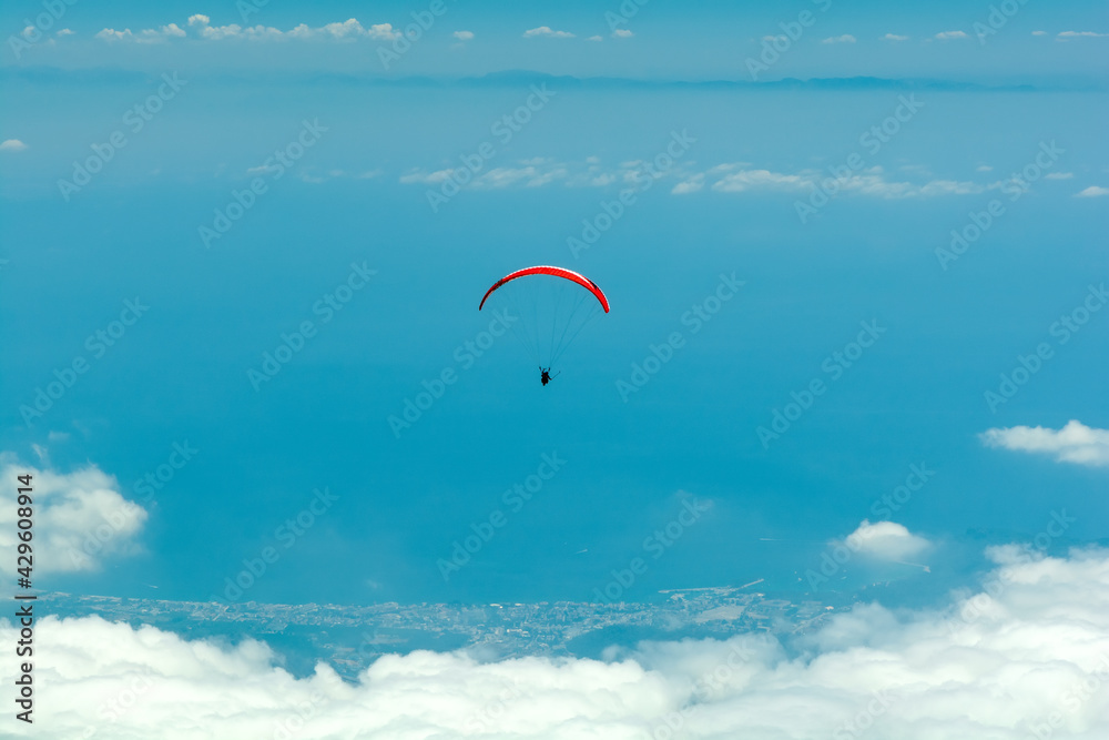 Paraglider flying in cloudy blue sky. Extreme sport. Landscape Paraglider flying in cloudy blue sky. Extreme sport. Landscape