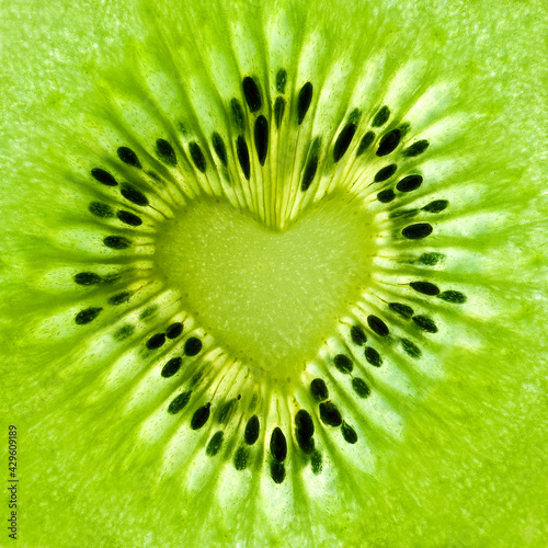 Fresh kiwi slice close up. Seeds in the shape of a  heart