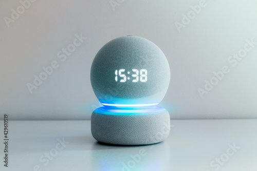 Voice controlled speaker with activated voice recognition, on light background.