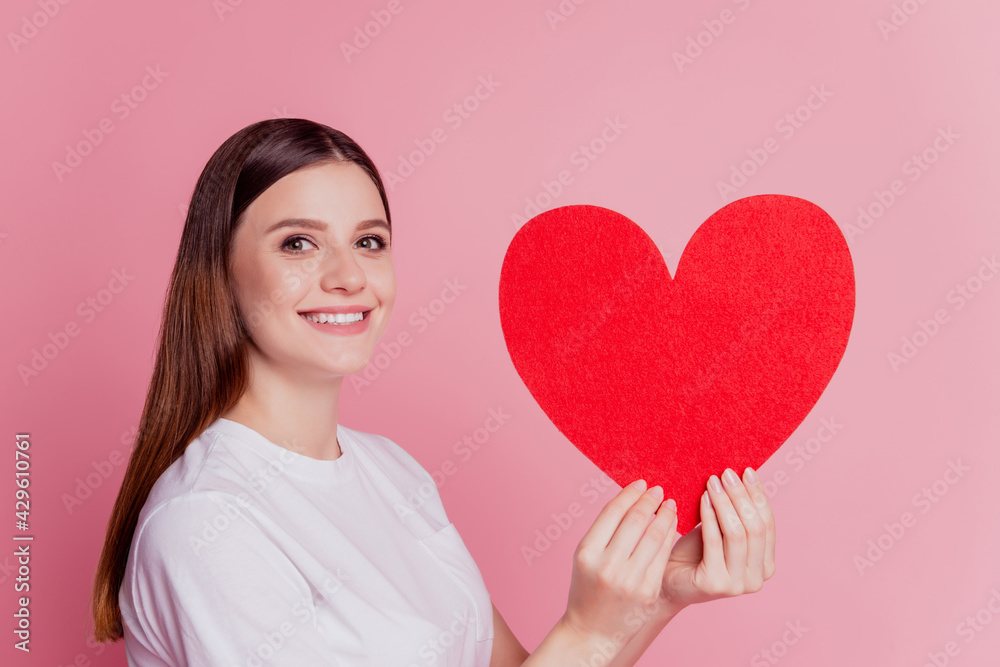Cheerful young beautiful girl hold red paper heart with fingers Cheerful young beautiful girl hold red paper heart with fingers