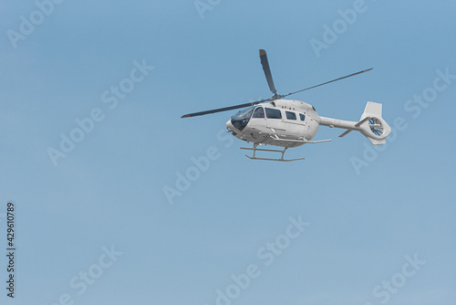 Helicopter for emergency evacuation of patients flying with blue sky background