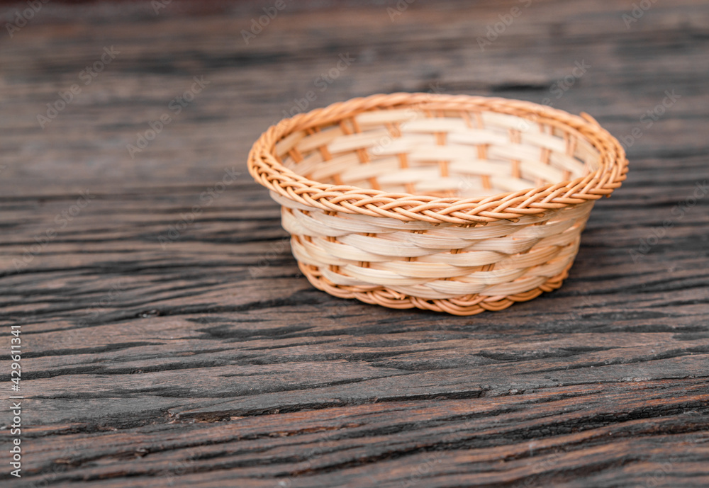 Wicker basket with copy space on wooden table Wicker basket with copy space on wooden table