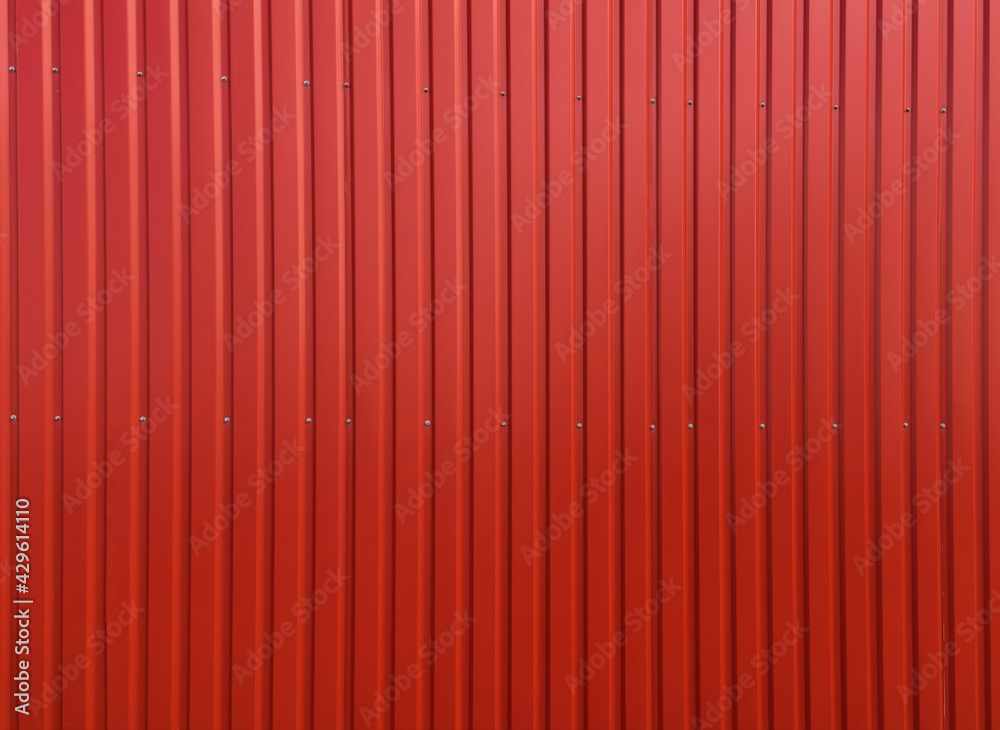 Building wall clad in red plastic siding Building wall clad in red plastic siding