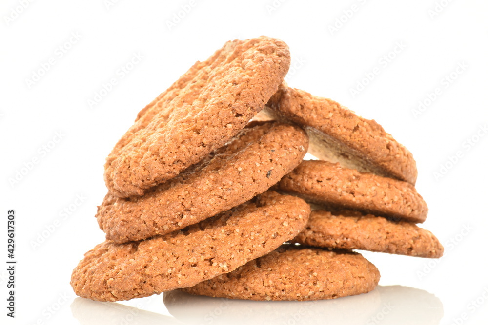 Several fragrant dark brown oatmeal cookies, close-up, isolated on white. Several fragrant dark brown oatmeal cookies, close-up, isolated on white.