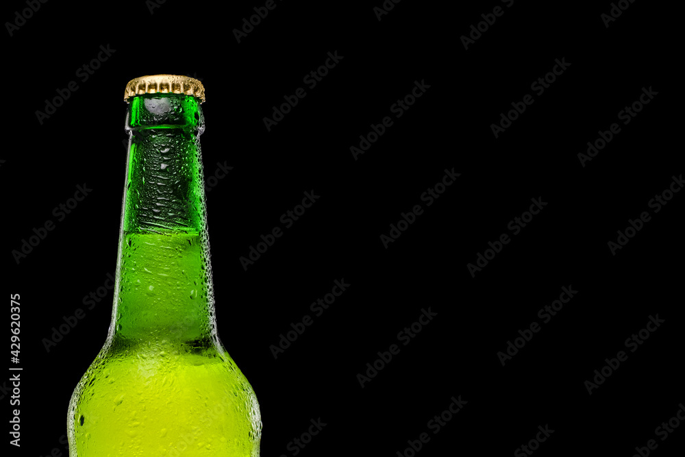 Green beer bottle isolated on black background. Place for text. Space for a logo or text.