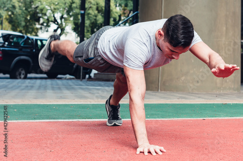 Young, athletic man doing push-ups. outdoors