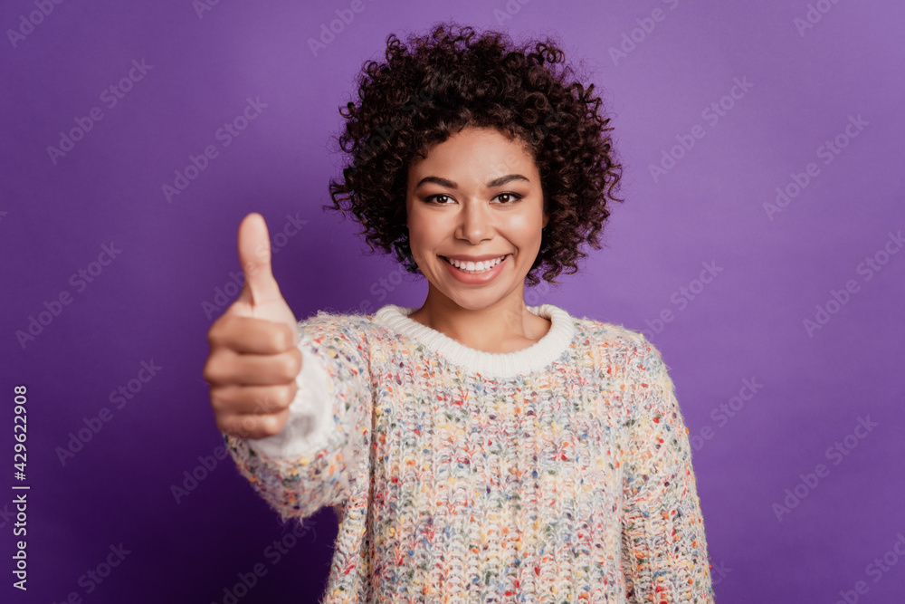 Happy young smiling african woman raise thumb up isolated on purple background Happy young smiling african woman raise thumb up isolated on purple background