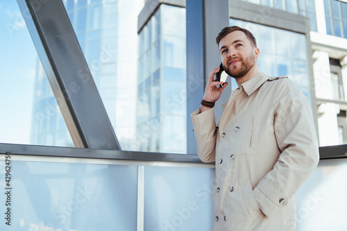 Man walks down the street and talks on phone photo