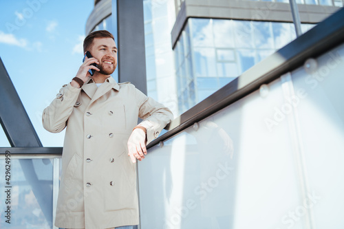 Man walks down the street and talks on phone photo