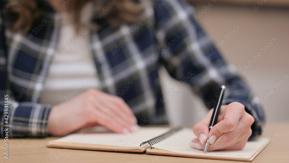 Female Hands Writing on Notebook, Close up Female Hands Writing on Notebook, Close up