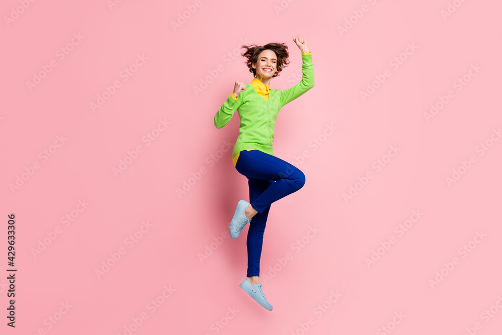 Full size photo of happy joyful pretty girl jump air fly superhero raise fists isolated on pastel pink color background