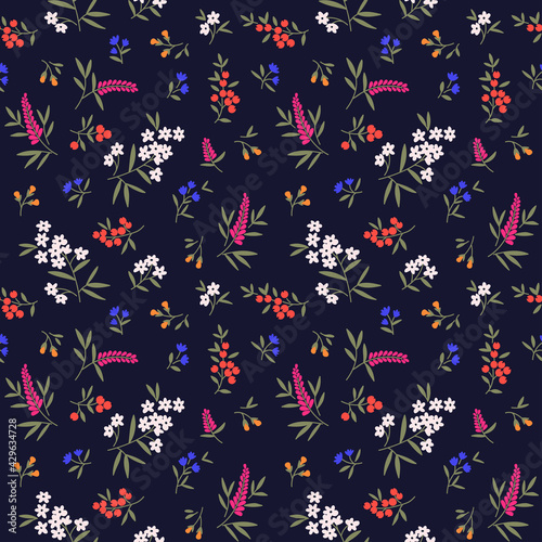 Beautiful floral pattern in small abstract flowers. Small colorful flowers. Dark blue background. Ditsy print. Floral seamless background. The elegant the template for fashion prints. Stock vector.
