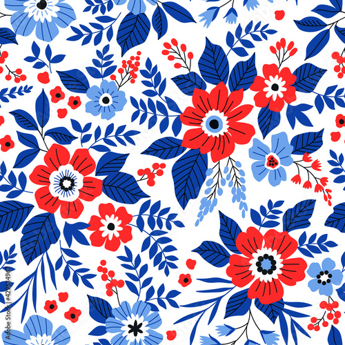 Beautiful floral pattern in small abstract flowers. Small red and blue flowers. White background. Ditsy print. Floral seamless background. The elegant the template for fashion prints.