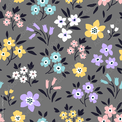 Elegant pattern in small flowers are scattered on the surface. Liberty style. Floral seamless background. Ditsy print. Vector texture. A bouquet of spring flowers for fashion prints. Stock vector.