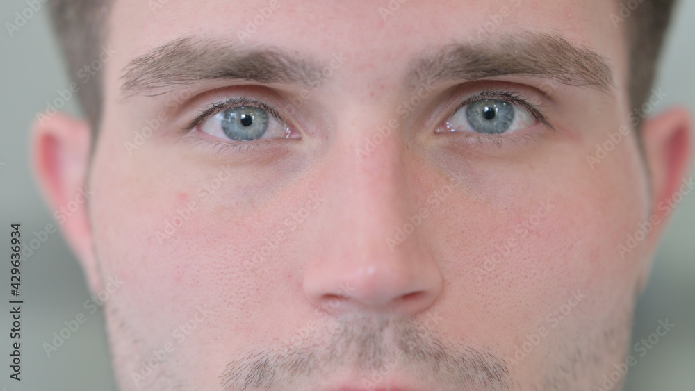 Naklejka premium Close up of Blinking Eyes of Attractive Young Man