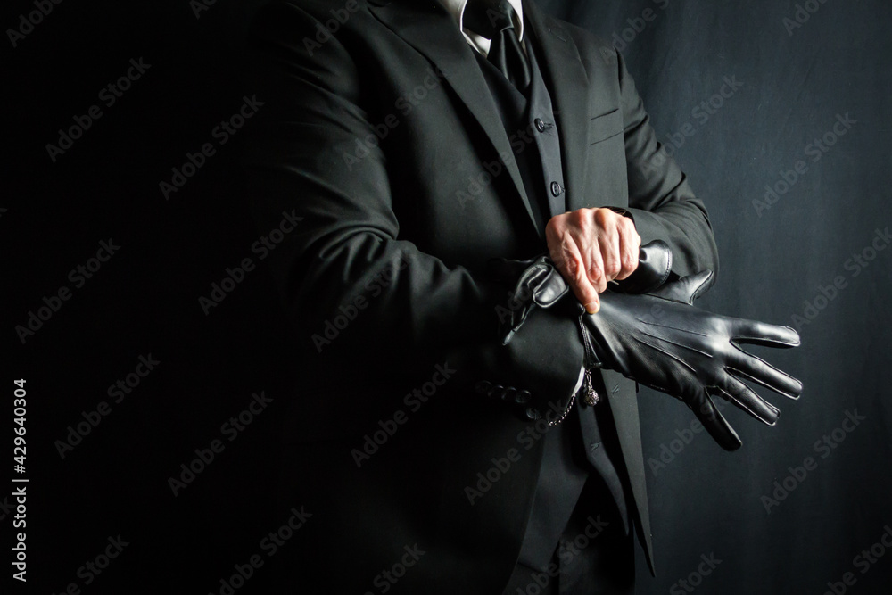 Portrait of Businessman in Dark Suit Pulling on Black Leather Gloves. Well  Dressed Mafia Hit Man. Gentleman Assassin. Stock-Foto | Adobe Stock