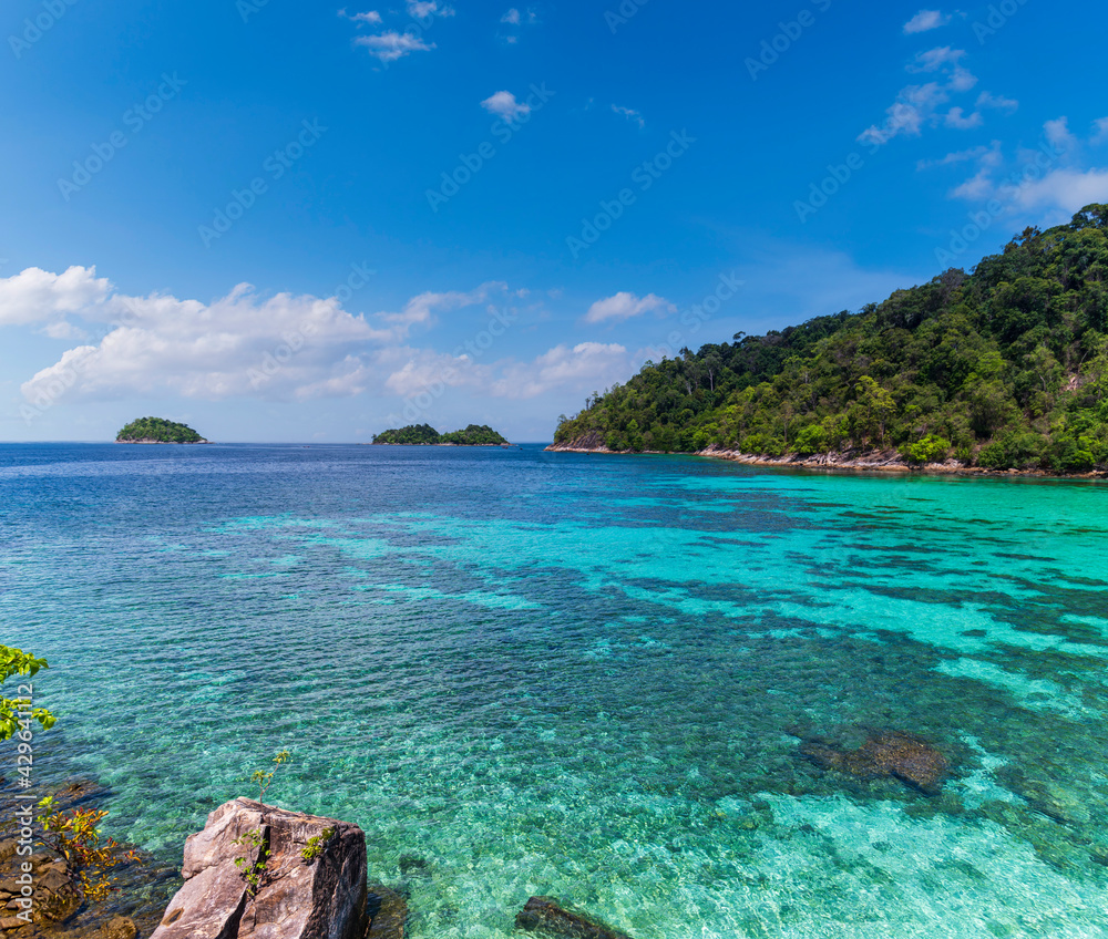 Beautiful Andaman sea, Tropical Turquoise clear blue sea and blue sky background at Lipe Island, Satun, Thailand -  summer  vacation travel
