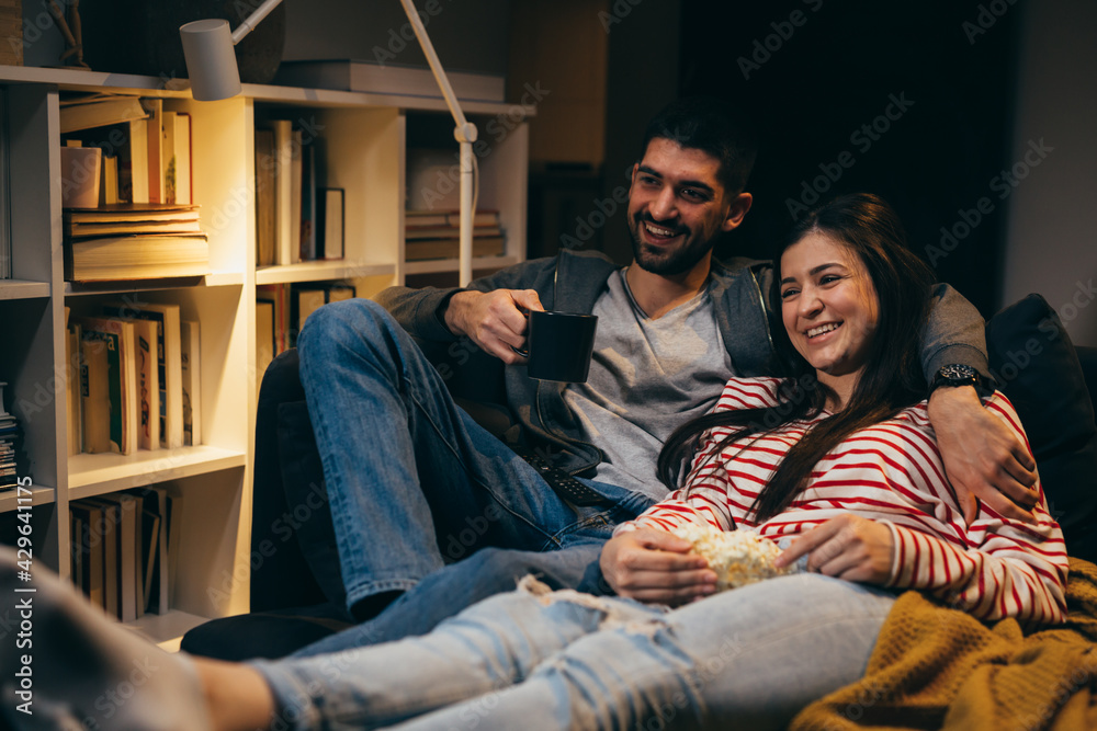couple watching tv at home