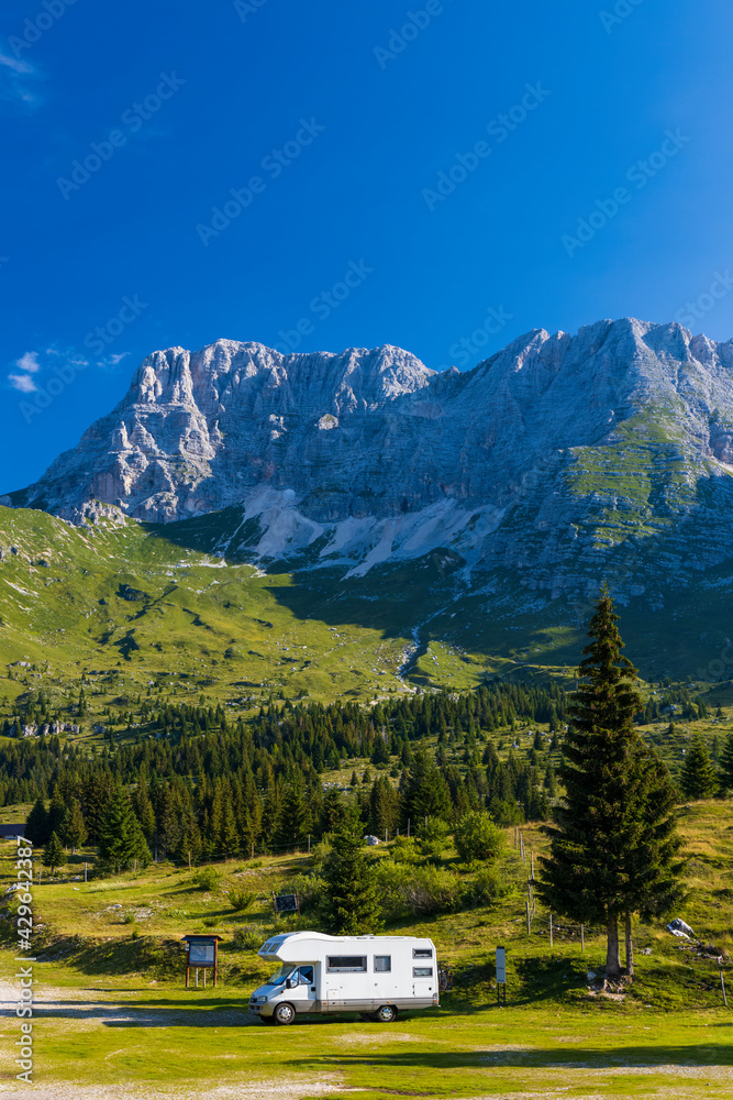 Caravan in summer mountain landscape, Alps, Italy