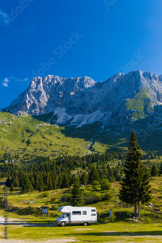 Caravan in summer mountain landscape, Alps, Italy