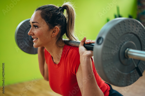 Woman using a barbell in the gym