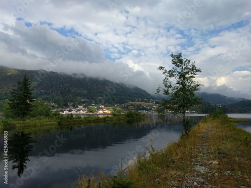 clouds over the lake with view of small town
