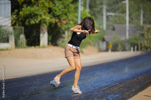 A woman walks on hot asphalt 